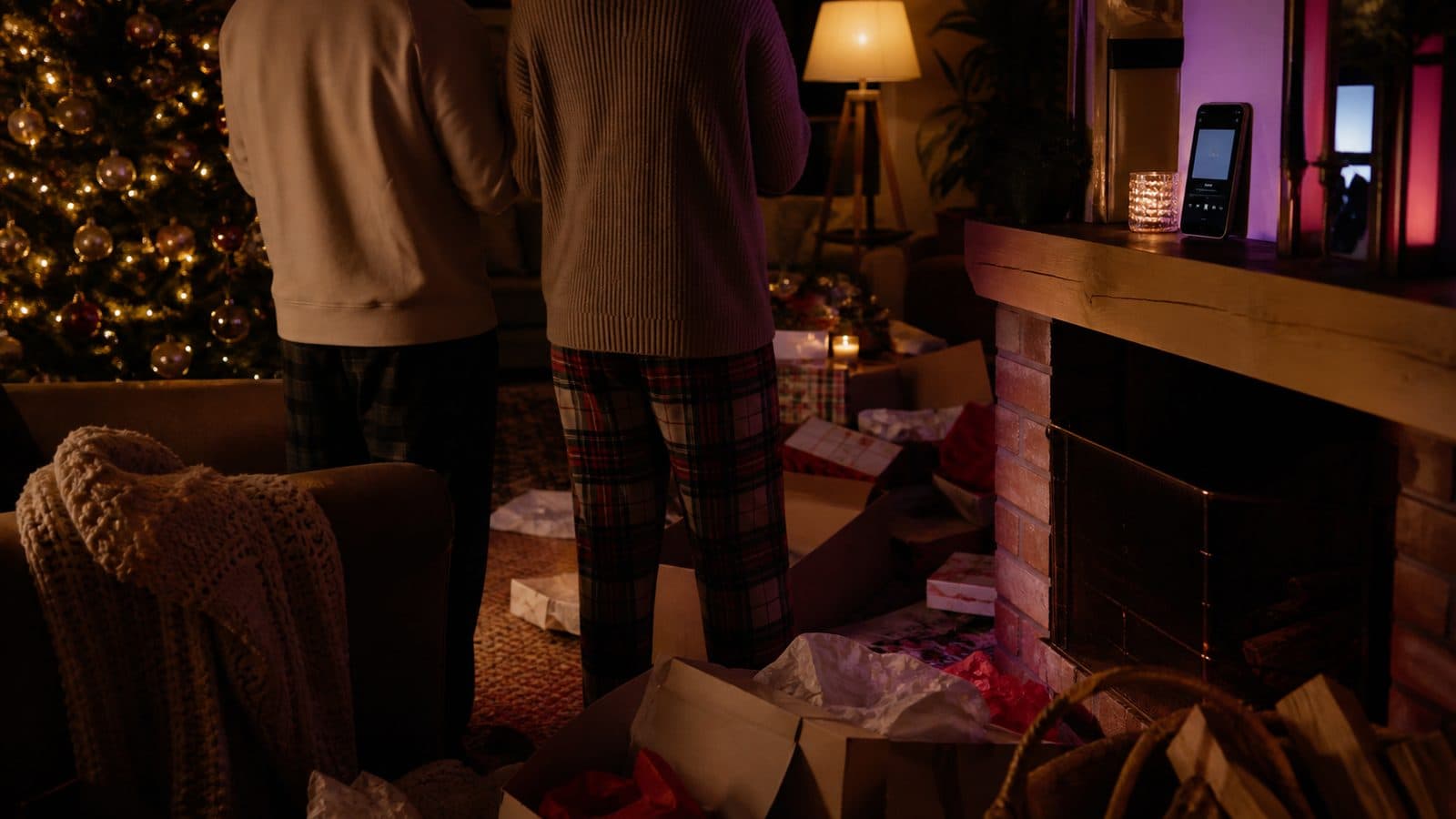 A family living room on Christmas morning with music playing from a phone