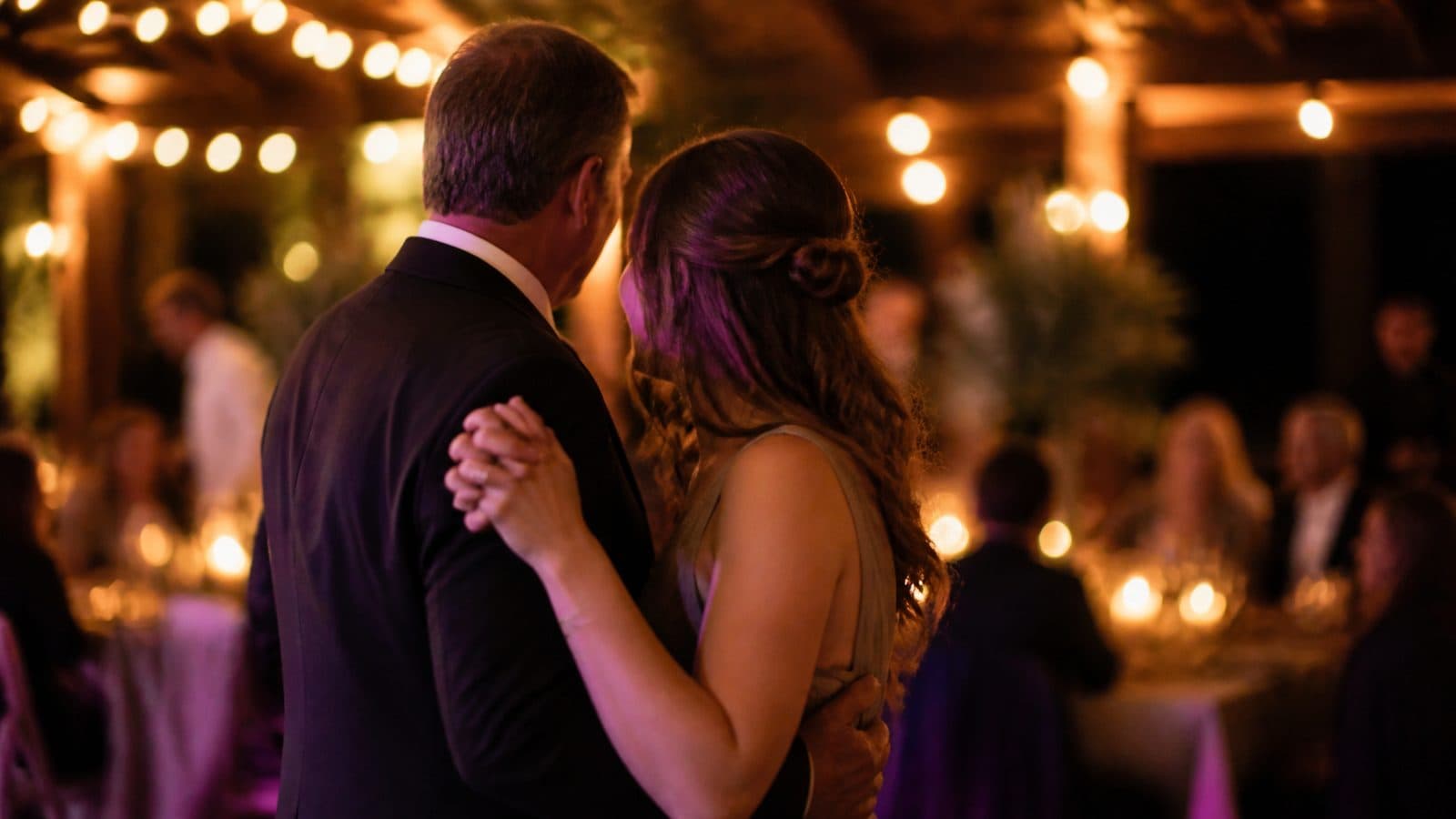 A father and his grown daughter dancing together at a wedding reception